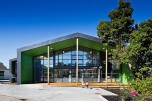 Modern building surrounded by trees and blue skies